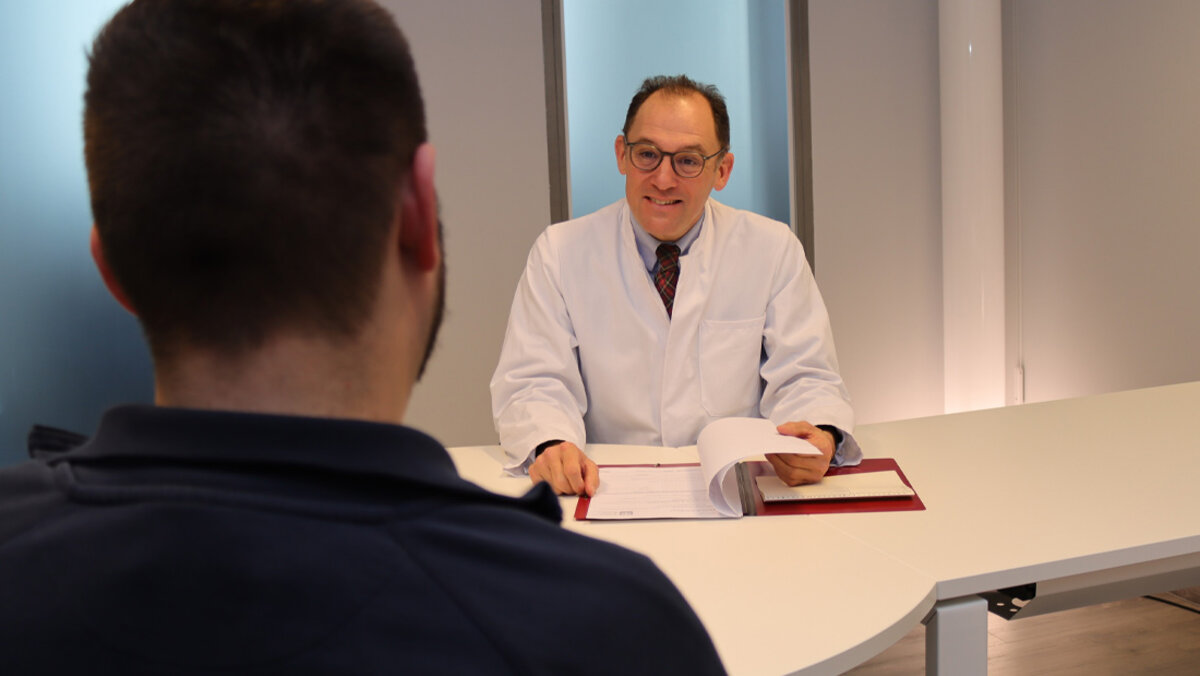 Leiter des Uroonkologischen Zentrums Prof. Dr. med. Maximilian Burger im Gespräch mit einem Patienten am Caritas-Krankenhaus St. Josef